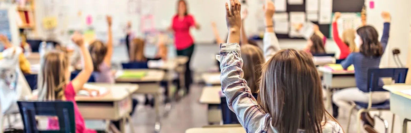 kids in school raising hands